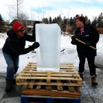 Brenda Solberg and Johnny Certo begin carving during the Sweet Pea Ice Carving Event.